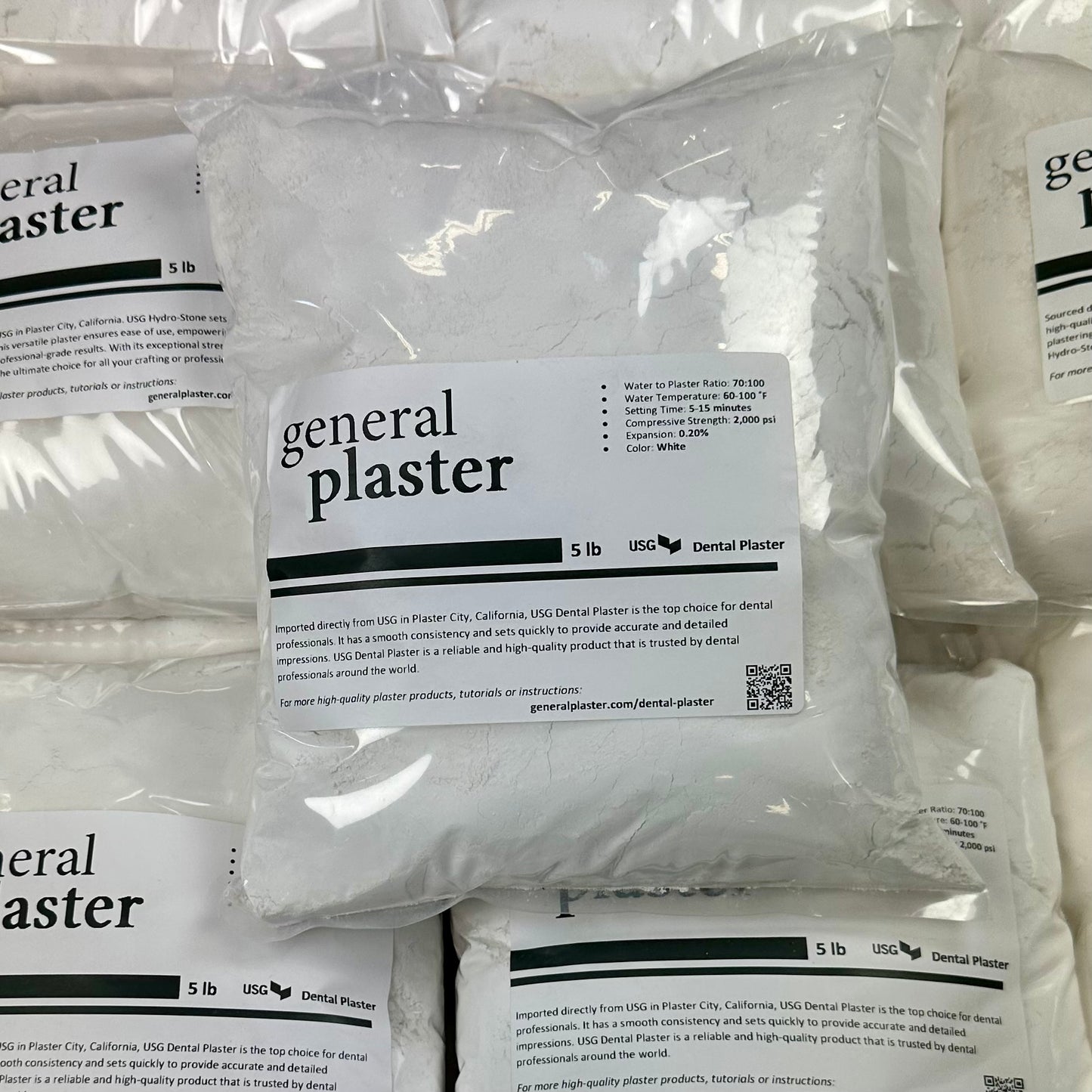 Sealed 5 lb bag of USG Dental Plaster from GP on a stack
