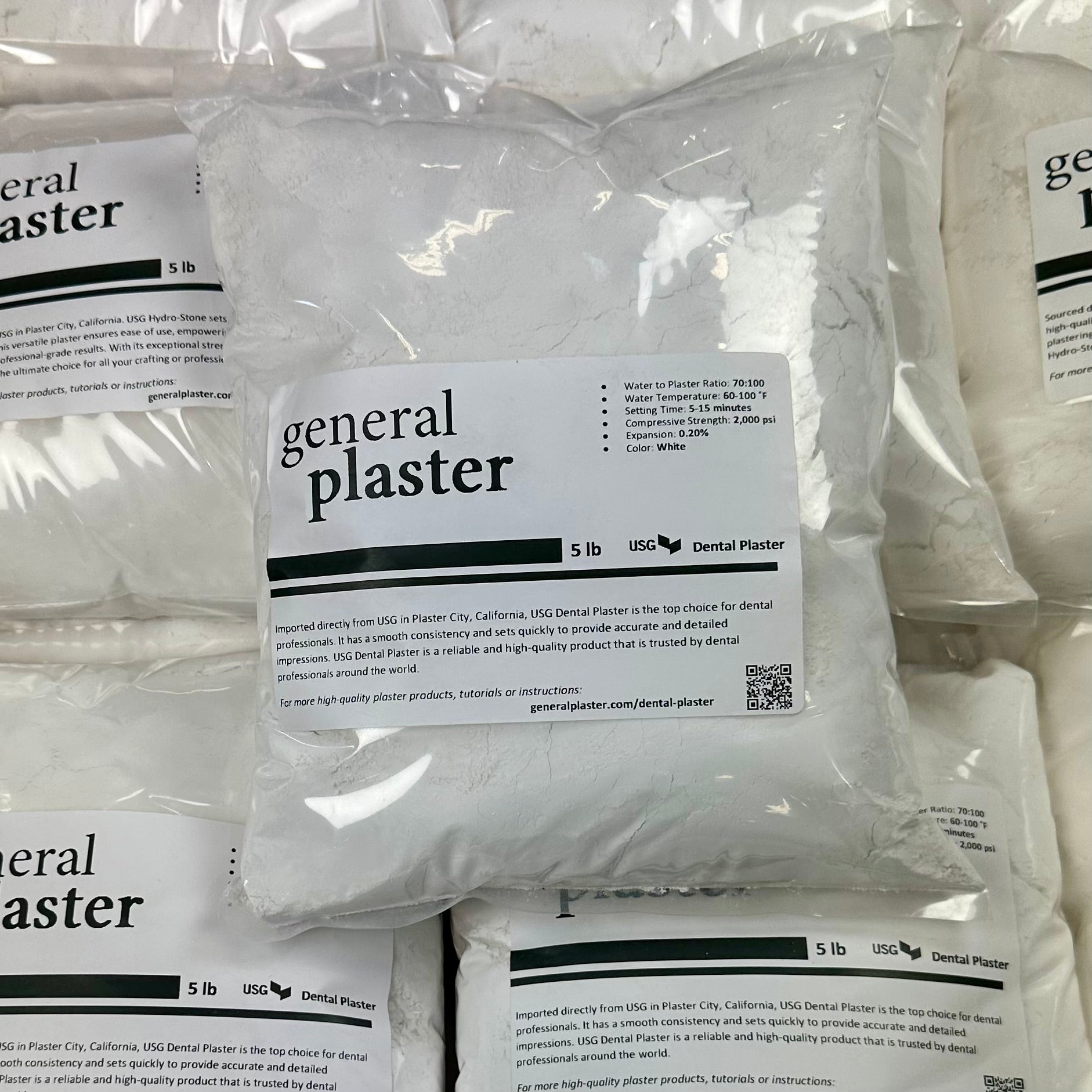 Sealed 5 lb bag of USG Dental Plaster from GP on a stack